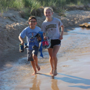 Campers running on the beach