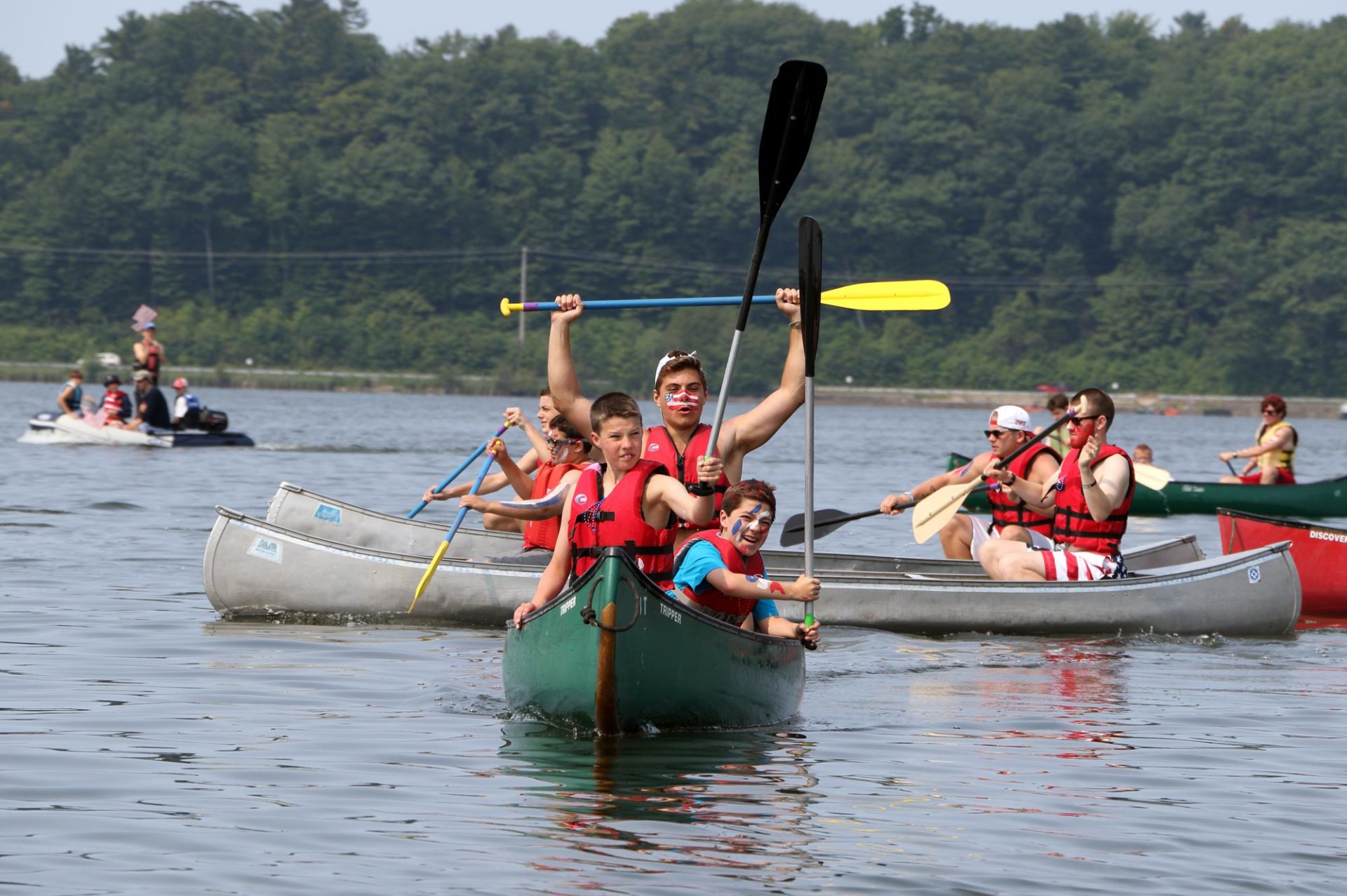 Camp Miniwanca Trailblazers in canoe wave paddles in celebration